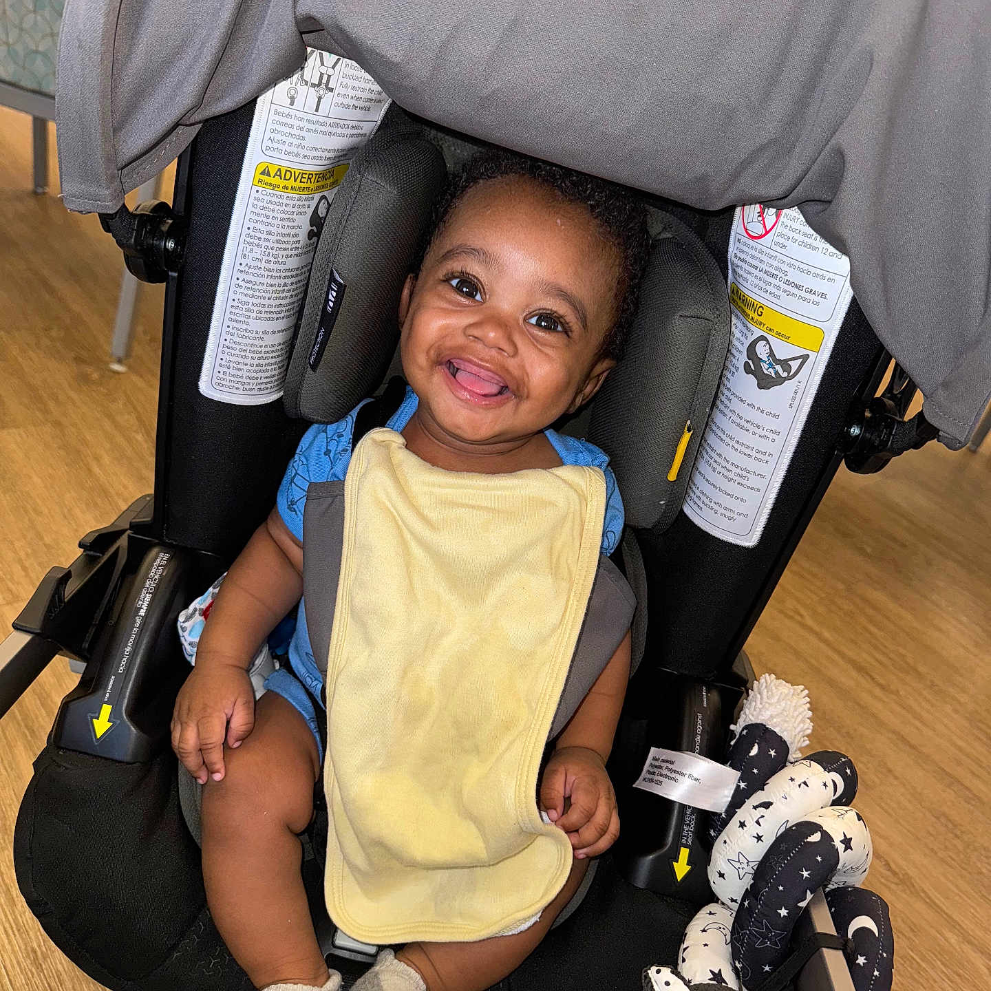 T Ruzin joined the competition — help win amazing prizes! baby, bib, black_and_white, child, clothing, comfort, cute, fabric, floor, happy, head_support, indoor, infant, patterned_wall, playful, seat, smiling, socks, stroller, toy