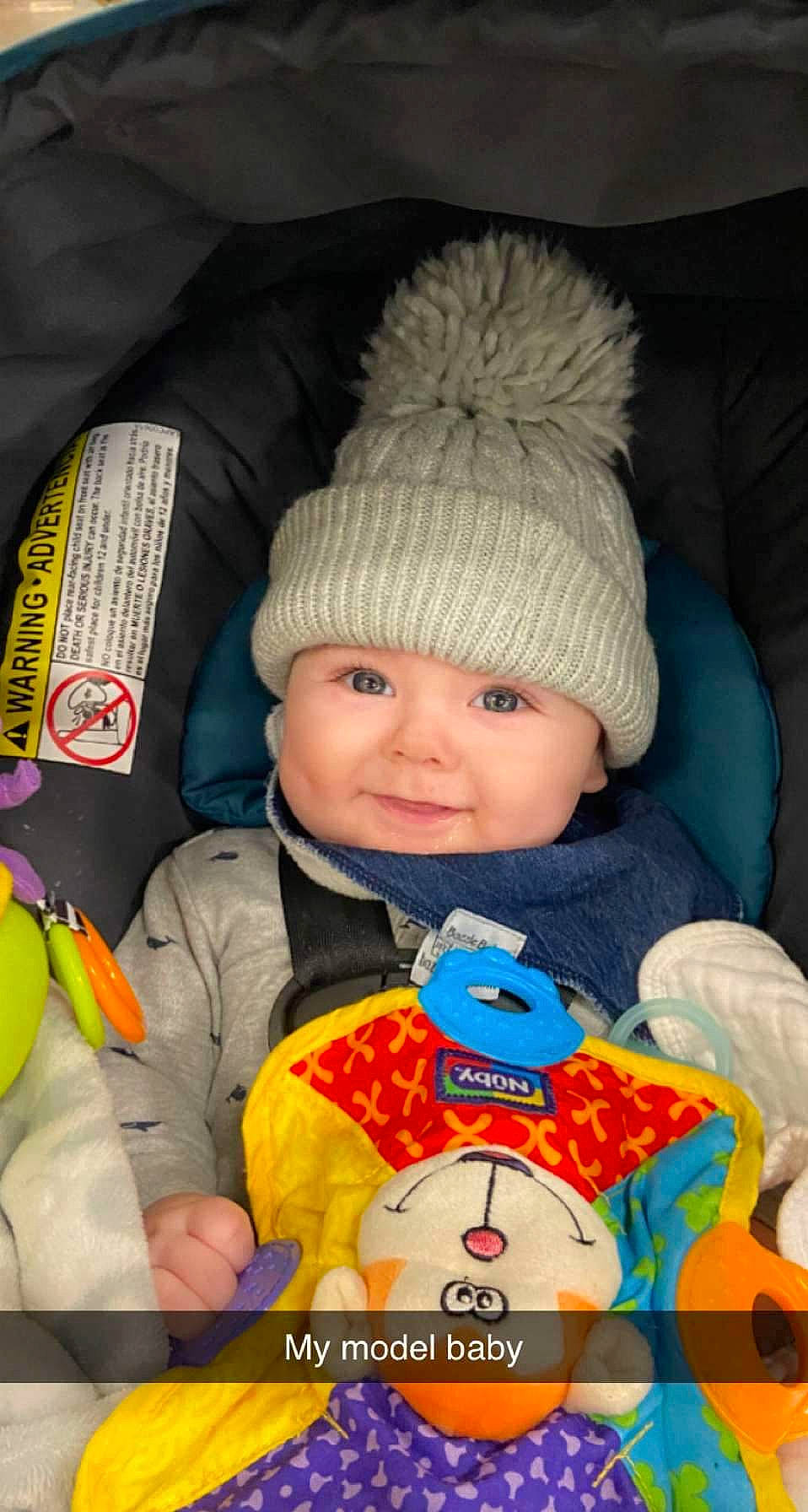 Zephyr joined the competition — help win amazing prizes! baby, baby_products, baby_toddler_clothing, beanie, cap, car_seat, cheek, child, comfort, fun, happy, headgear, headwear, knit_cap, orange, person, sitting, smile, toddler, white