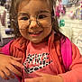 Waverly is registered to the contest to win money with this photo: accessories, backpack, casual, child, clothing, cute, face, fashion, glasses, hair, hand, happy, indoor, leisure, person, pink_jacket, portrait, smiling, store, young_child
