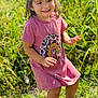 Waverly is registered to the contest to win money with this photo: casual_clothing, child, cute, daylight, footwear, grass, greenery, happy, nature, outdoor, person, pink_dress, portrait, rainbow_design, smiling, standing, sunny_day, toddler, white_sandals, young_child