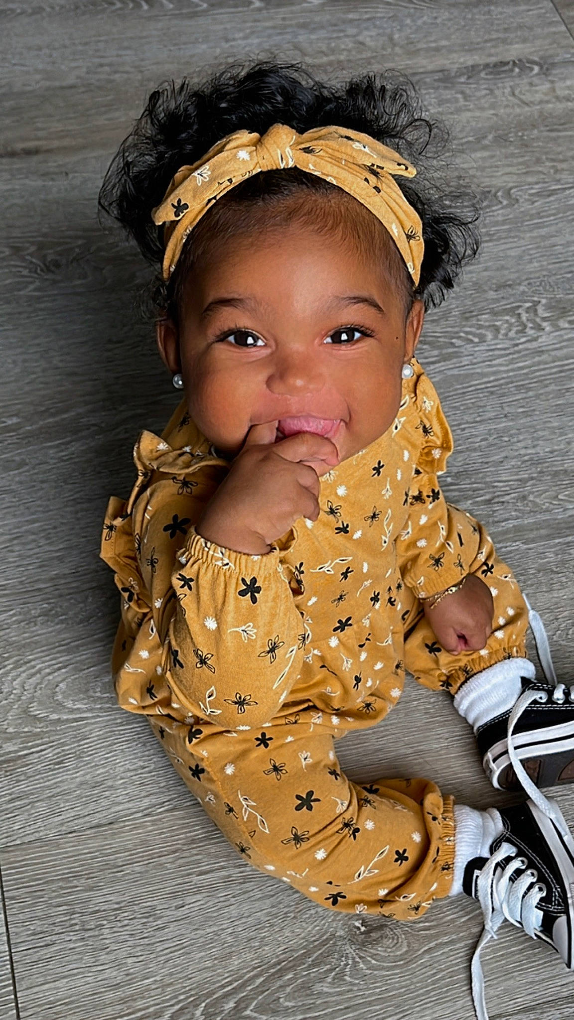 Amiri is registered to the contest to win money with this photo: baby, baby_toddler_clothing, cap, child, cool, face, finger, fun, gesture, happy, head, headgear, jacket, lip, neck, outerwear, pattern, person, skin, sleeve