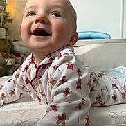 Arthur joined the competition — help win amazing prizes! baby, infant, smiling, pajamas, gingerbread_men, cushion, indoor, toy, plush_toy, happy, face, child, clothing, bedroom, cute, portrait, lying_down, soft_light, warm, home