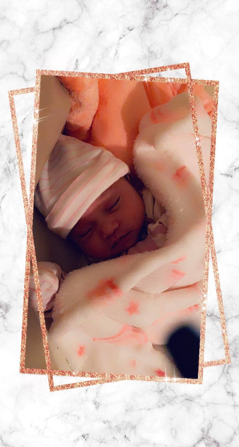 Ariadne is registered to the contest to win money with this photo: baby, baby_sleeping, bed, bedding, bedtime, comfort, eyebrow, eyelash, font, happy, headwear, linens, magenta, person, petal, picture_frame, pink, rectangle, room, skin
