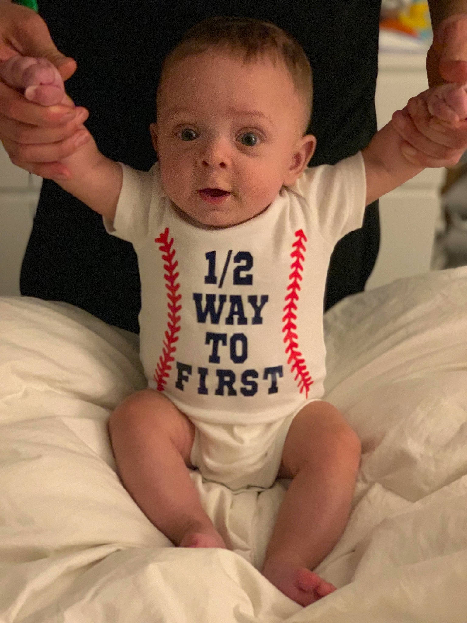 Jensen is registered to the contest to win money with this photo: arm, baby, baby_products, baby_toddler_clothing, cheek, child, person, sitting, sleeve, t_shirt, toddler