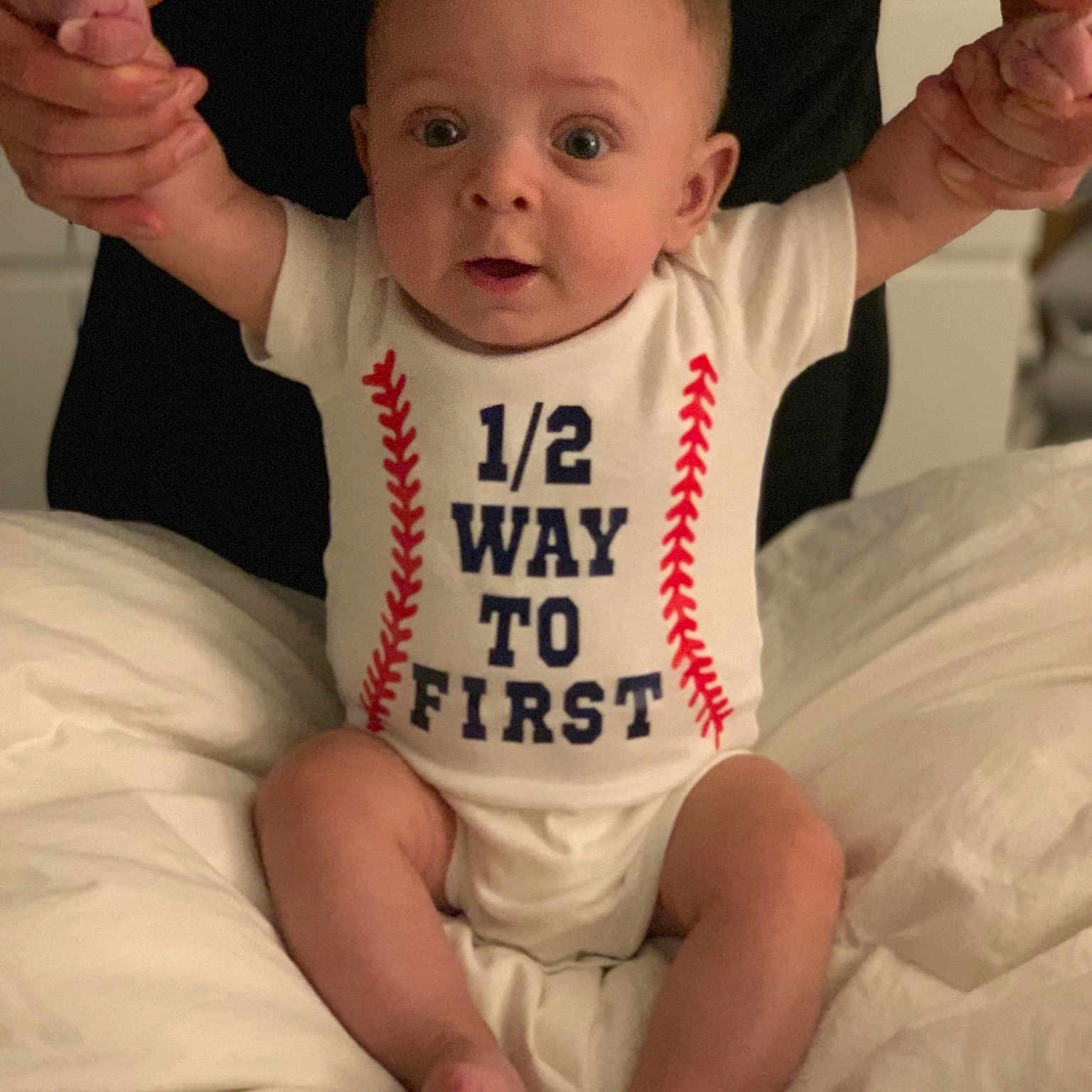 Jensen is registered to the contest to win money with this photo: arm, baby, baby_products, baby_toddler_clothing, cheek, child, person, sitting, sleeve, t_shirt, toddler