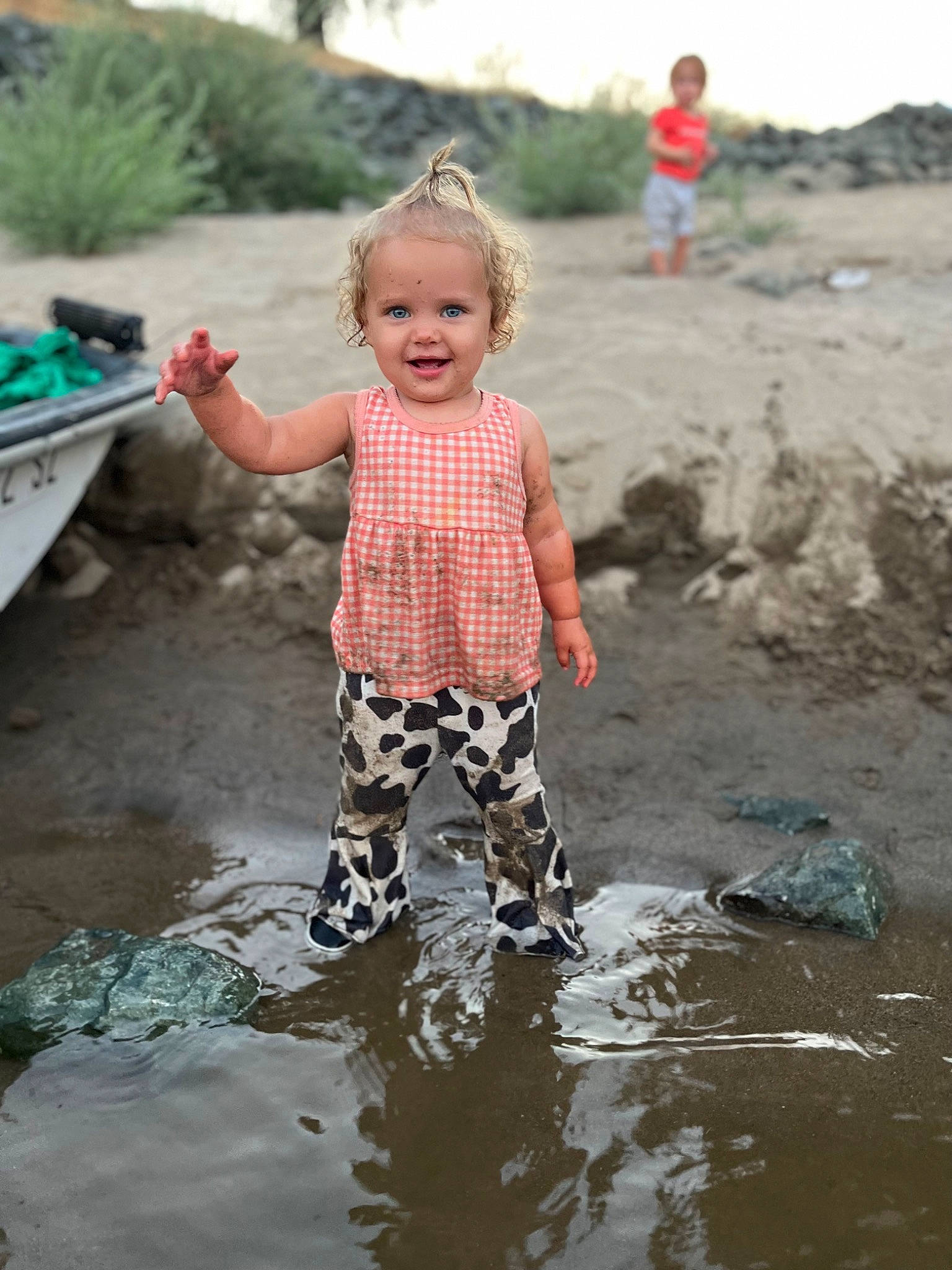 Rylee is registered to the contest to win money with this photo: adaptation, baby_toddler_clothing, boat, fun, happy, joy, leisure, morning, natural_environment, nature, people_in_nature, person, puddle, recreation, sand, sky, smile, soil, t_shirt, toddler