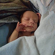 Elijah is registered to the contest to win money with this photo: newborn, baby, sleeping, blanket, cozy, soft, infant, wrapped, peaceful, resting, hand, face, bed, comfort, cute, warm, skin, portrait, child, indoors