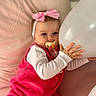 Alba a rejoint le concours — aidez-le/la à gagner de superbes lots ! baby, infant, girl, pacifier, pink_bow, balloon, pillow, romper, corduroy, long_sleeve_shirt, toddler, cute, soft_lighting, indoors, child, headband, hand, white_balloon, pink, relaxed
