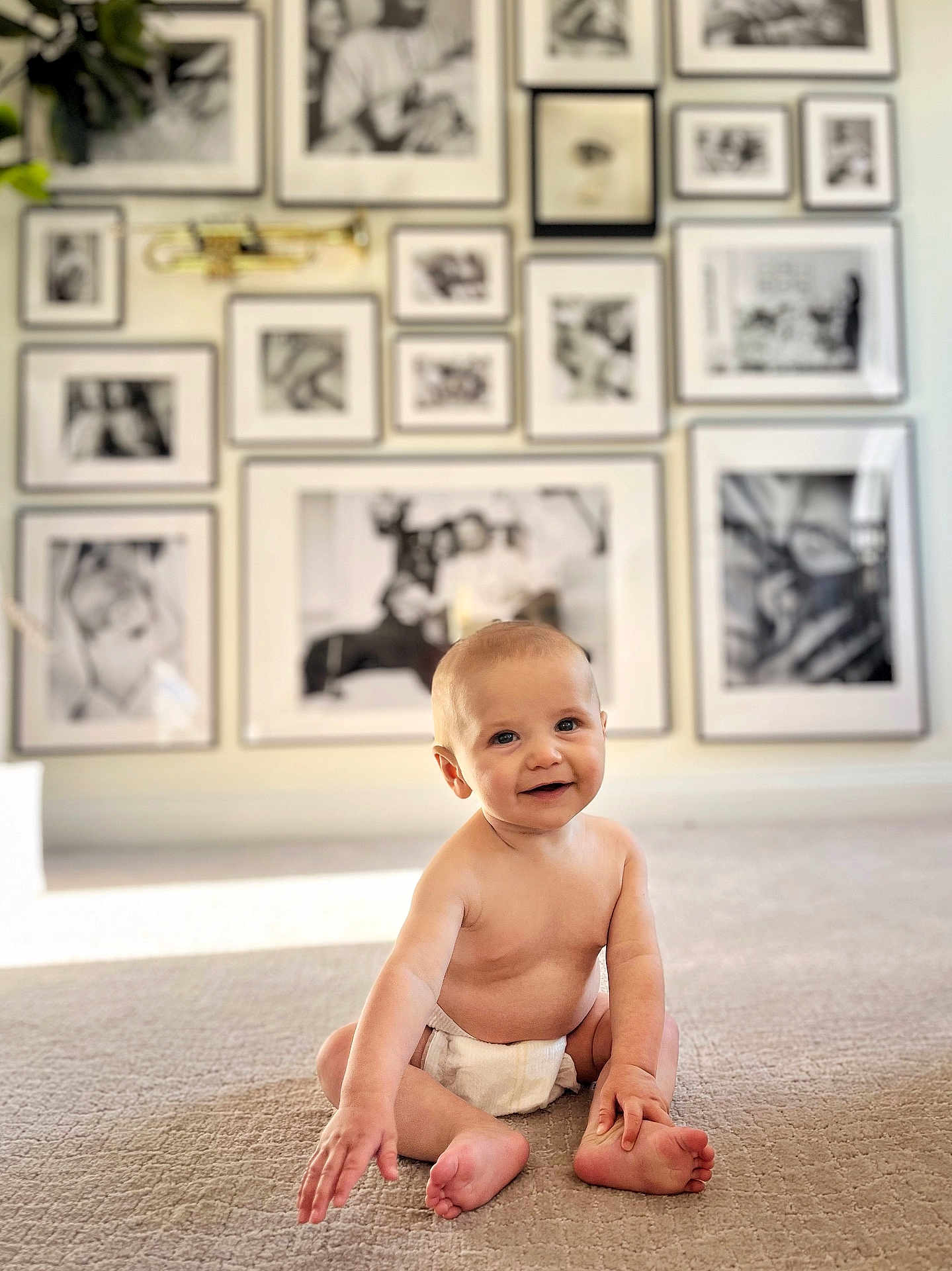 Kendrick is registered to the contest to win money with this photo: arm, baby, babylaughing, blonde, boy, child, crawling, diaper, face, hair, happy, head, male, person, photography, plant, portrait, pottedplant, sitting, smile