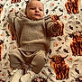 Evelyn joined the competition — help win amazing prizes! baby, infant, blanket, knitwear, beige, highland_cow, floral_crown, pattern, cute, lying_down, child, soft_texture, warm_clothing, footwear, adorable, portrait, indoor, comfort, animal_print, peaceful
