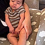 baby, sleeping, child, striped_clothing, arm, hand, cushion, cloud_pattern, furniture, indoor, person, comfort, rest, cute, peaceful, toddler, skin, legs, holding, relaxation