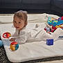 baby, child, indoor, blanket, toy, colorful, pajamas, floor, couch, window, happy, smiling, play, soft, carpet, white, gray, tiled_floor, infant, young_child