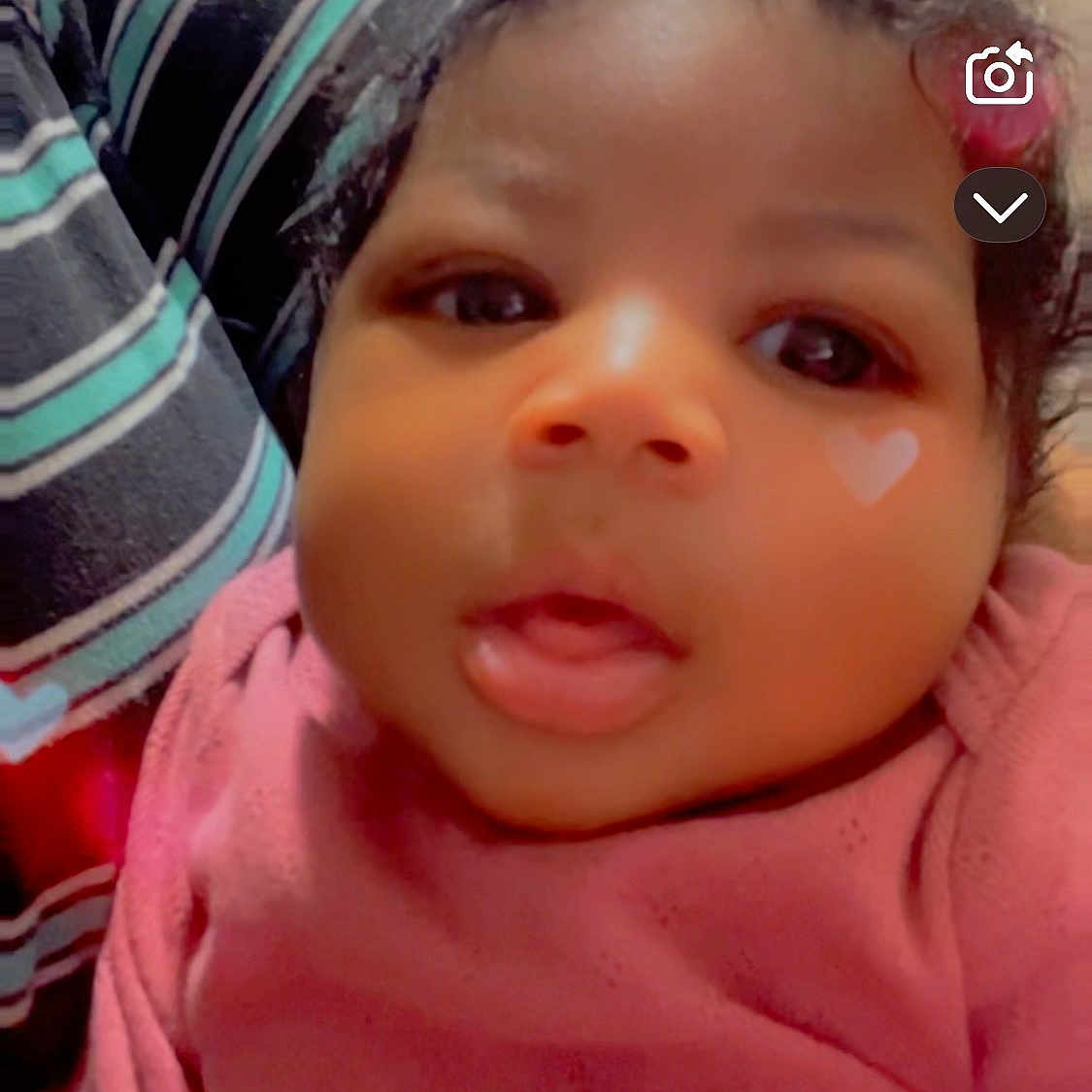 Demariya joined the competition — help win amazing prizes! baby, infant, face, closeup, pink_clothing, heart_shape, curly_hair, striped_fabric, indoors, portrait, child, cute, expression, person, skin, head, young, app_icons, digital_overlay, soft_lighting