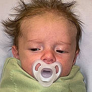 Ezrah is registered to the contest to win money with this photo: baby, pacifier, blanket, infant, hair, face, sleepy, cute, newborn, child, person, skin, head, expression, indoors, portrait, young, wrapped, clothing, resting