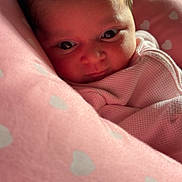Sahara joined the competition — help win amazing prizes! baby, infant, face, pink_blanket, heart_pattern, wrapped, closeup, cute, newborn, soft_texture, portrait, child, resting, indoors, warm, cozy, sleepwear, head, person, expression