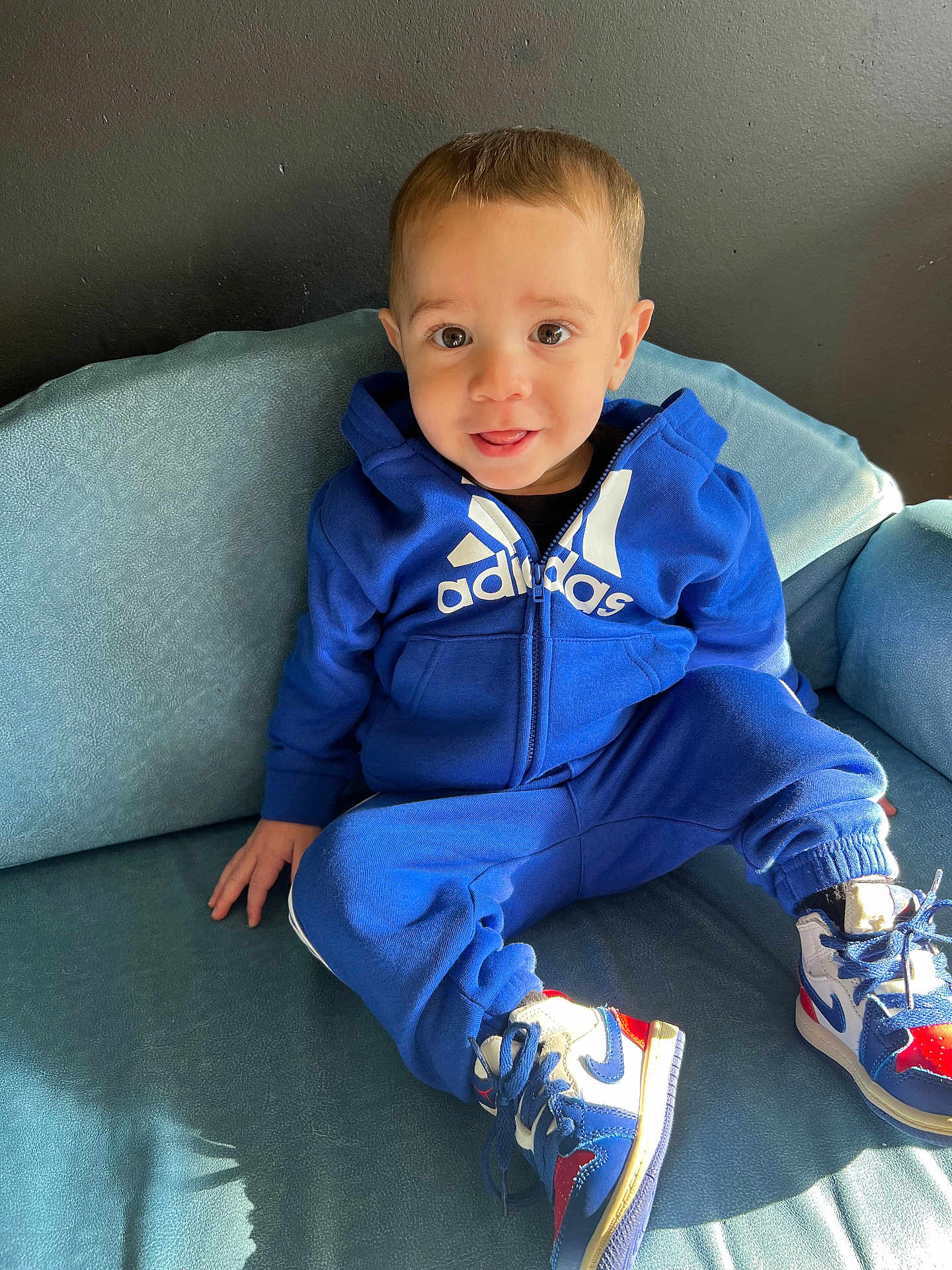 Dayziel joined the competition — help win amazing prizes! toddler, child, blue_tracksuit, adidas, sneakers, armchair, smiling, happy, indoor, portrait, cute, young_child, sitting, clothing, footwear, person, face, casual, comfortable, fashion