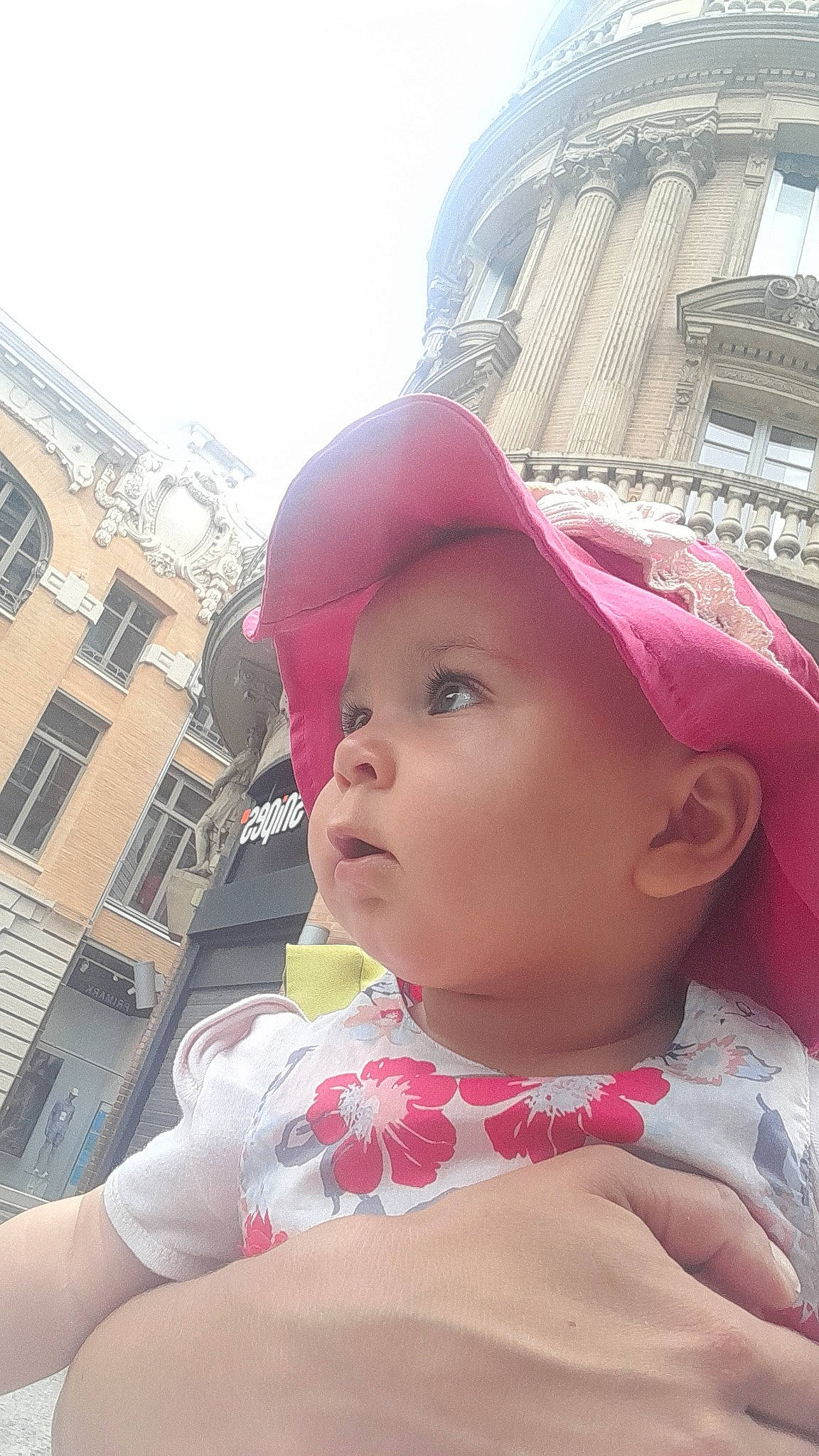 Ana-liyah a rejoint le concours — aidez-le/la à gagner de superbes lots ! baby, baby_toddler_clothing, building, cap, carmine, child, chin, fashion_accessory, fun, happy, hat, headwear, leisure, lip, magenta, person, pink, sky, toddler, travel
