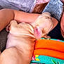 arm, blanket, couch, cozy, cuddle, dog, ear, floral_blanket, glasses, head, human, indoor, nap, orange_blanket, pet, pillow, puppy, skin, sleeping, velvet