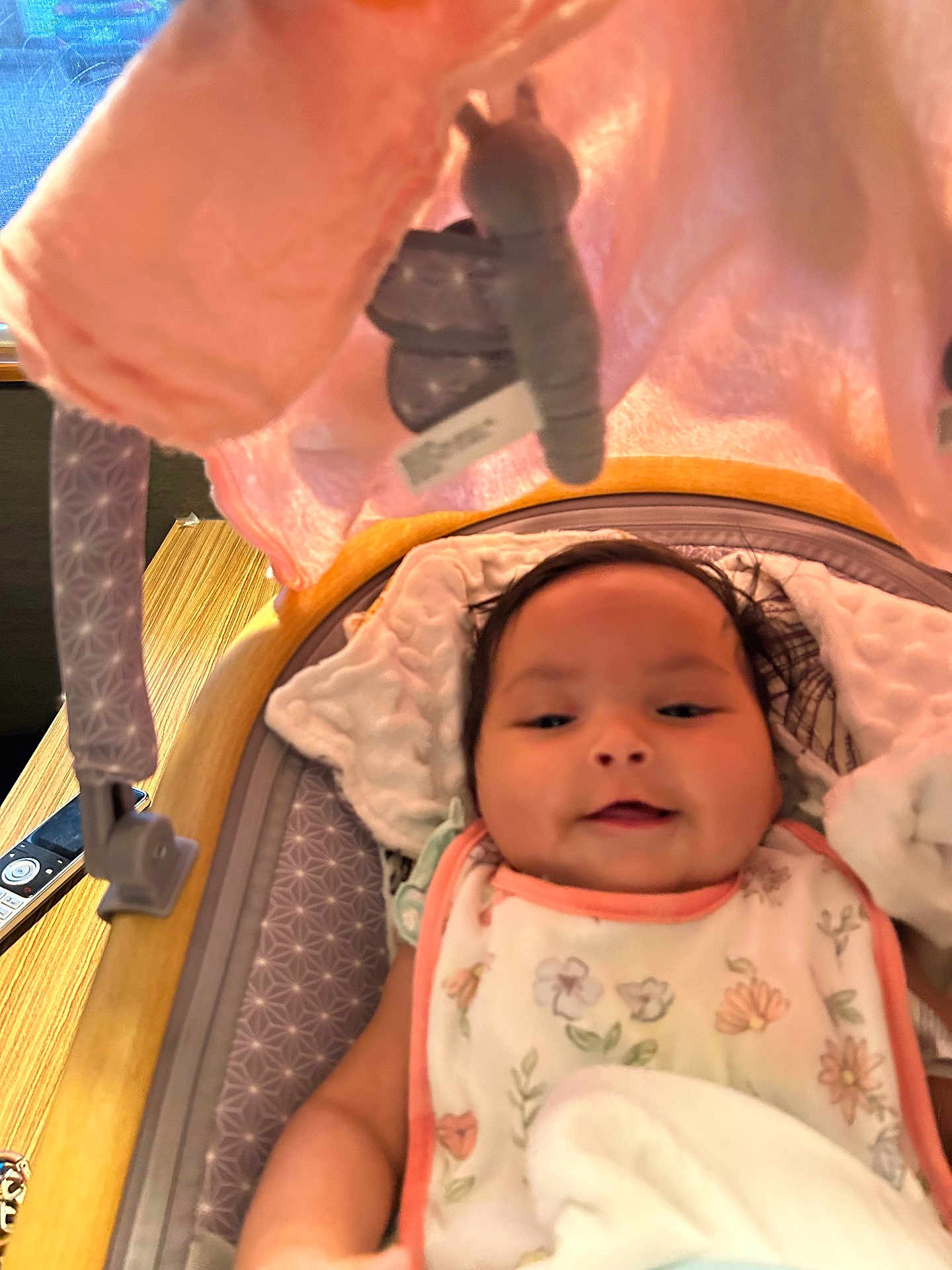 Vada is registered to the contest to win money with this photo: baby, infant, smile, bib, baby_seat, plush_toy, blanket, flower_pattern, face, cushion, indoor, child, cute, soft_toy, pink, relaxing, young_child, happy, portrait, lying_down