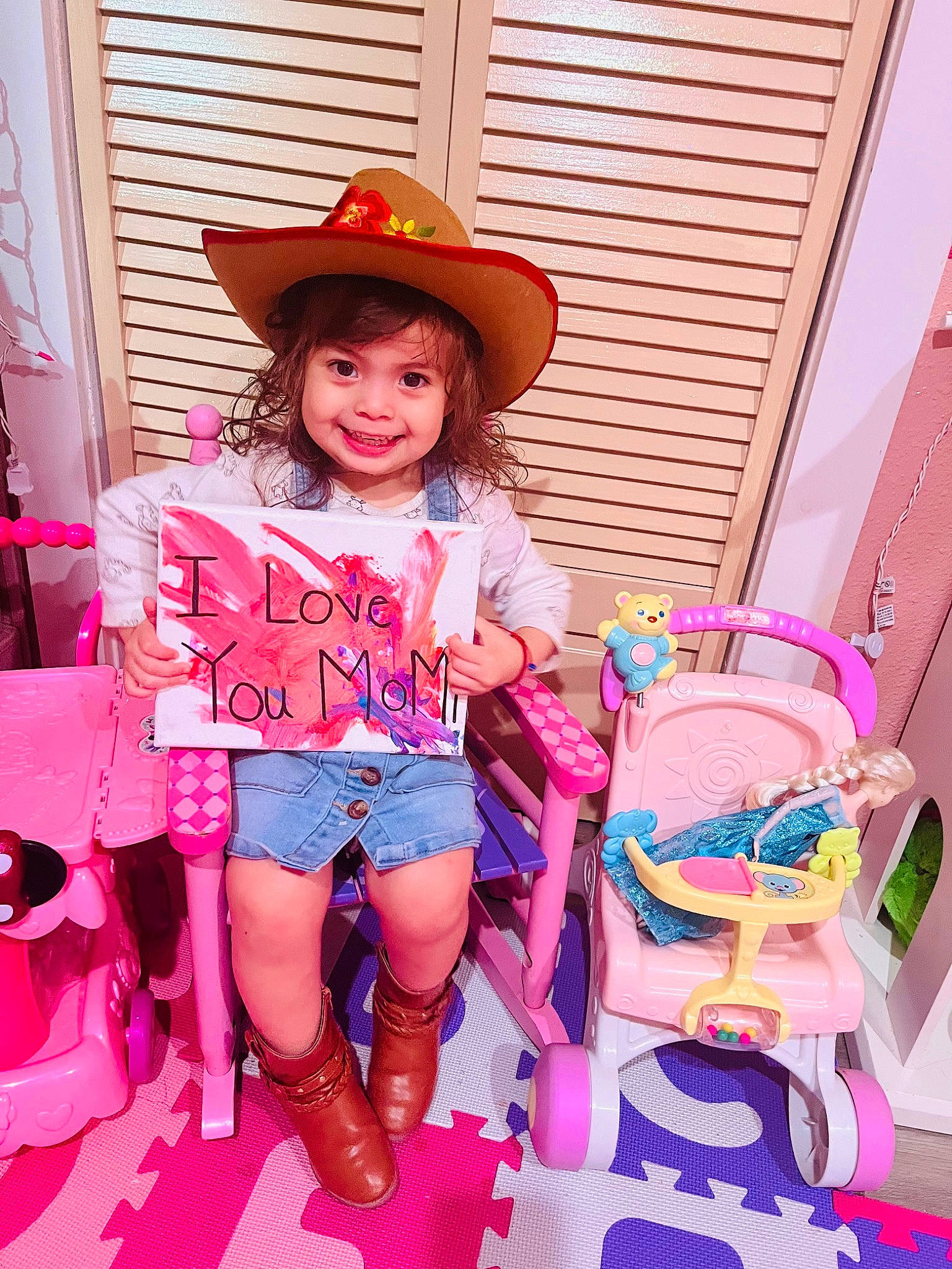 Maddie is registered to the contest to win money with this photo: baby_toddler_clothing, child, cool, cowboy_hat, event, facial_expression, fun, happy, hat, human, joy, leisure, magenta, person, pink, purple, shorts, skin, smile, sun_hat
