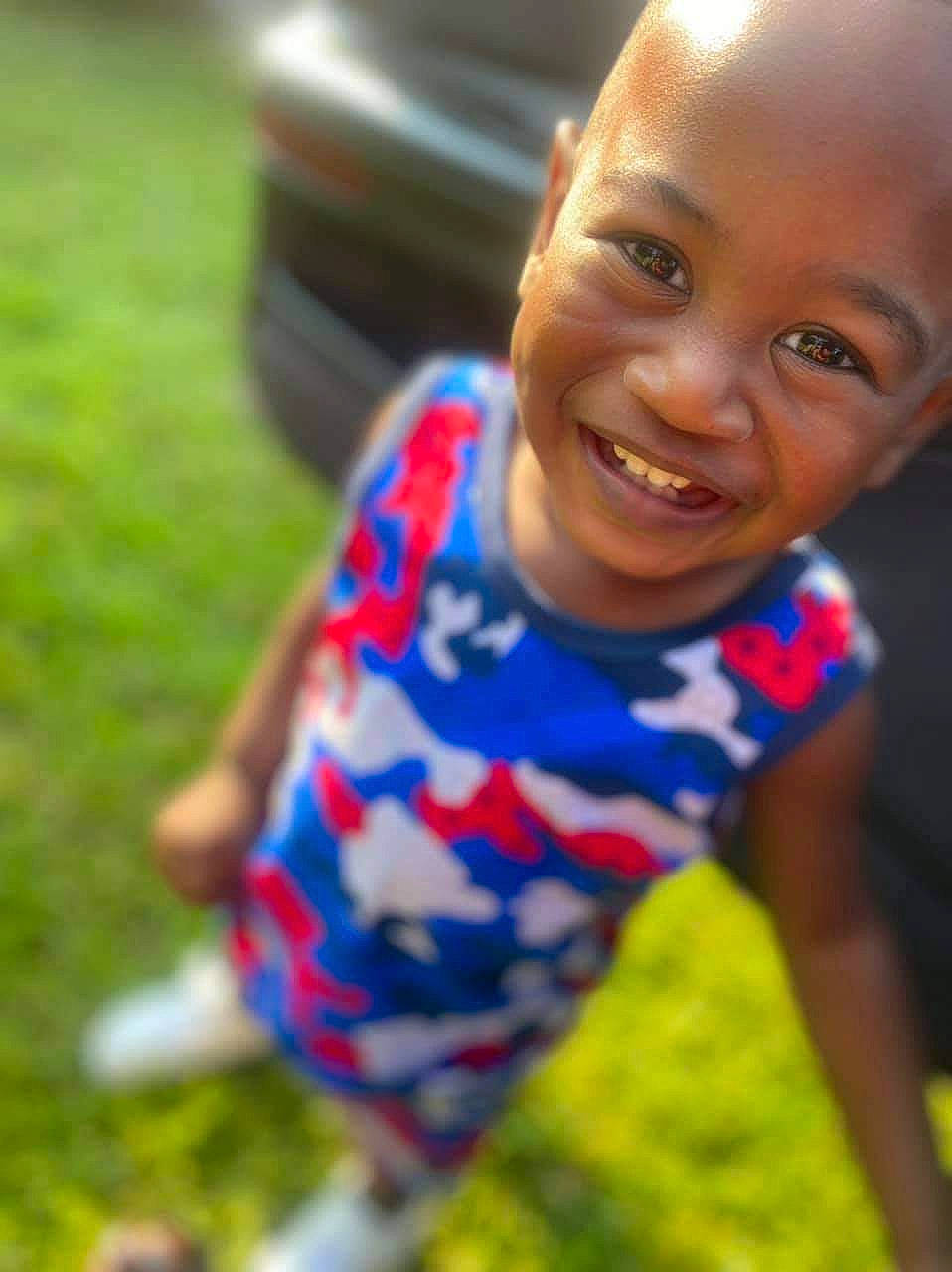 Jamison joined the competition — help win amazing prizes! automotive_exterior, automotive_tire, child, electric_blue, eye, finger, fun, grass, happy, human_body, iris, joy, lawn, leisure, person, plant, recreation, sitting, smile, summer