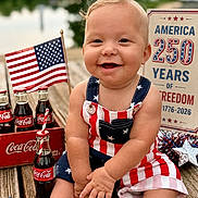 Wesley joined the competition — help win amazing prizes! american_flag, baby, bottle, celebration, child, clothing, coca_cola, cute, drink, happy, holiday, outdoor, patriotic, person, portrait, red_white_blue, smile, star, summer, wooden_deck