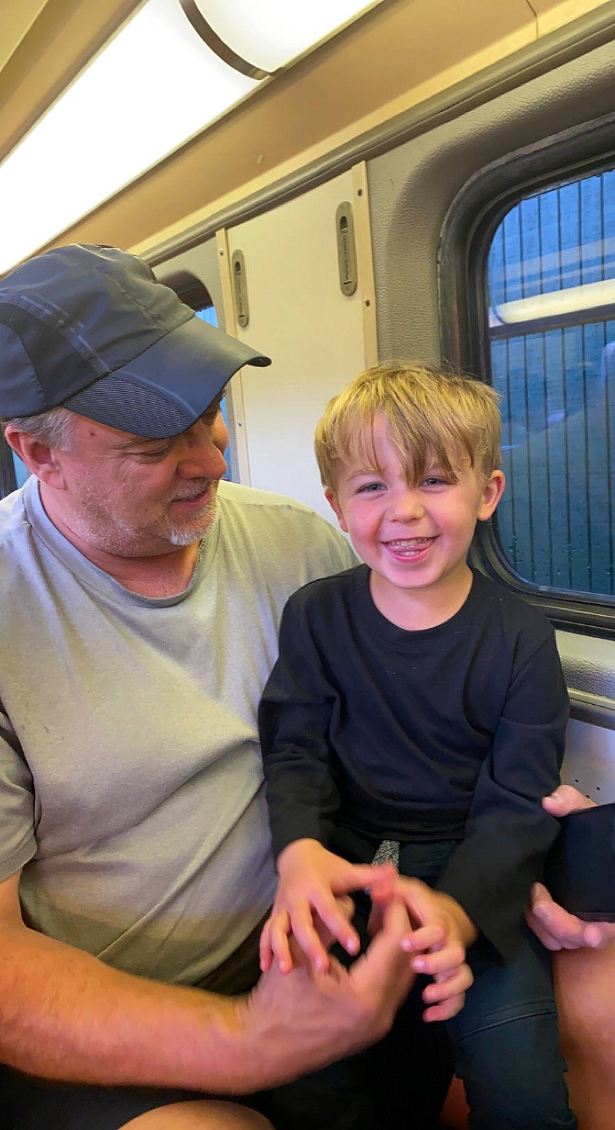 Brooks joined the competition — help win amazing prizes! baseball_cap, cap, child, event, fun, hat, headwear, joy, lap, leisure, necklace, people, person, recreation, shorts, sitting, smile, t_shirt, toddler, vacation