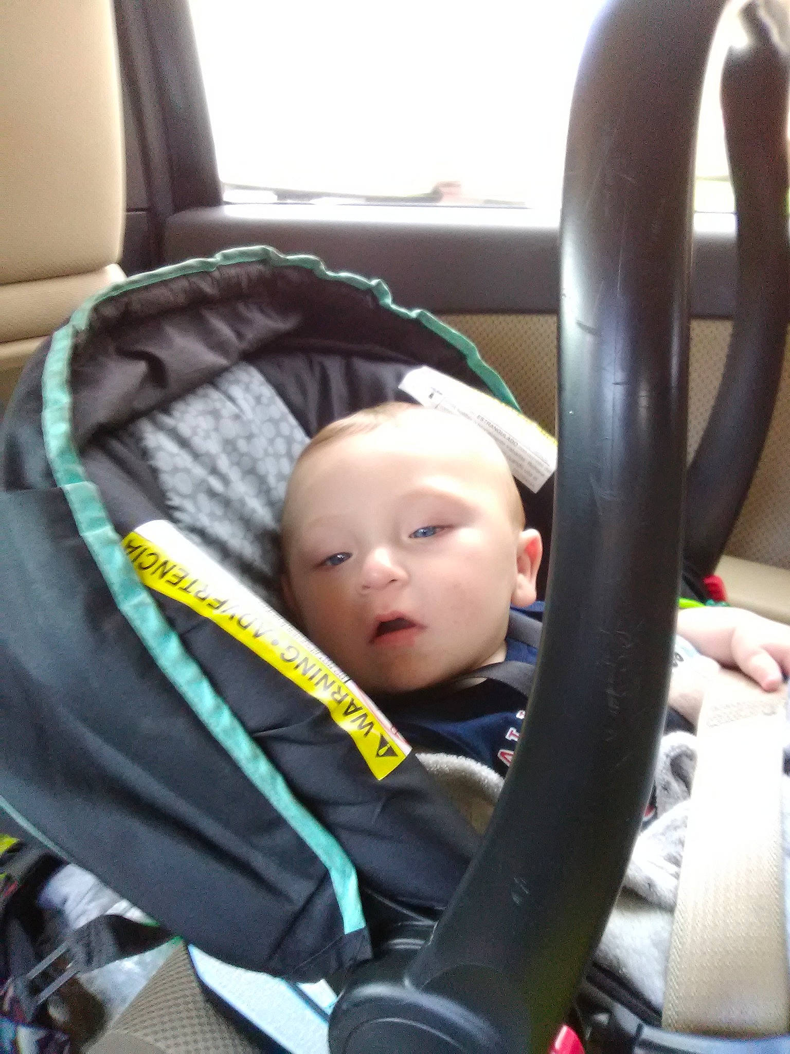 Clifford is registered to the contest to win money with this photo: auto_part, baby, baby_carriage, baby_in_car_seat, baby_products, car_seat, car_seat_cover, child, comfort, person, product, steering_part, steering_wheel, toddler