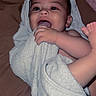 baby, towel, infant, chewing, happy, playful, skin, face, hand, foot, bed, blanket, indoors, child, person, cute, smile, closeup, soft, relaxing