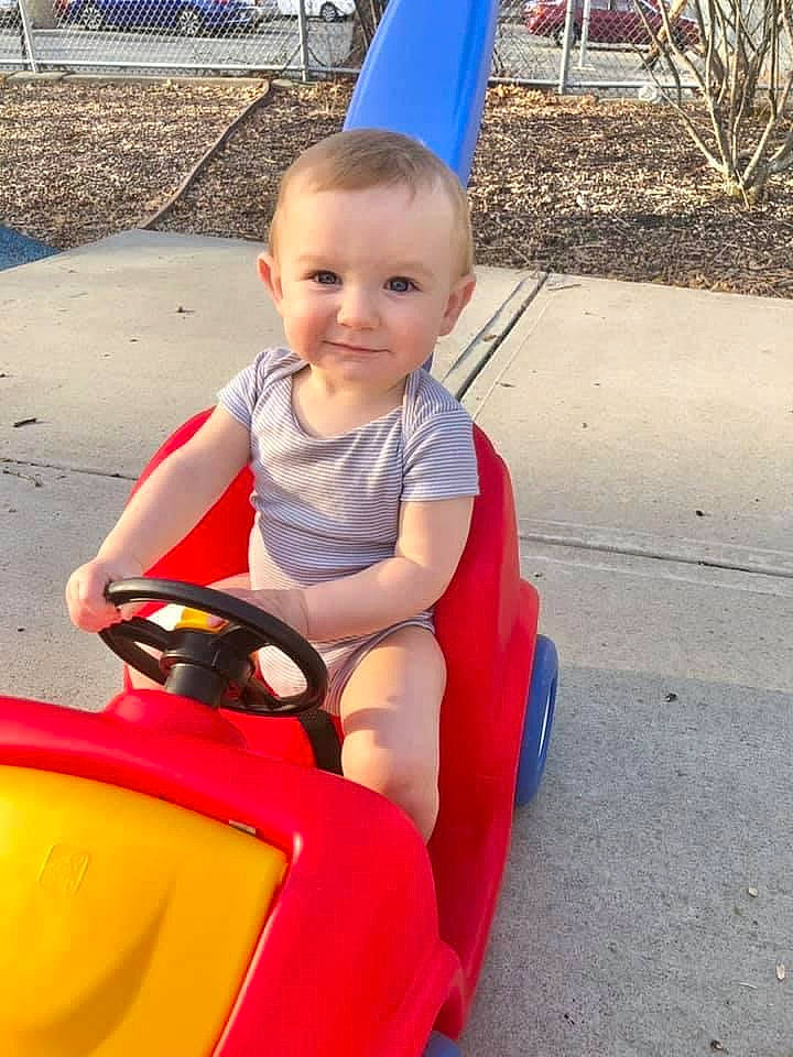 Lincoln joined the competition — help win amazing prizes! baby, baby_toddler_clothing, child, city, facial_expression, fun, grass, happy, human_body, joy, leisure, person, play, recreation, riding_toy, sitting, skin, smile, tire, toddler