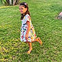 child, girl, colorful_dress, grass, greenery, plants, outdoor, playful, smiling, sandals, hair_accessory, sunlight, nature, summer, vacation, park, people, tree, happy, portrait