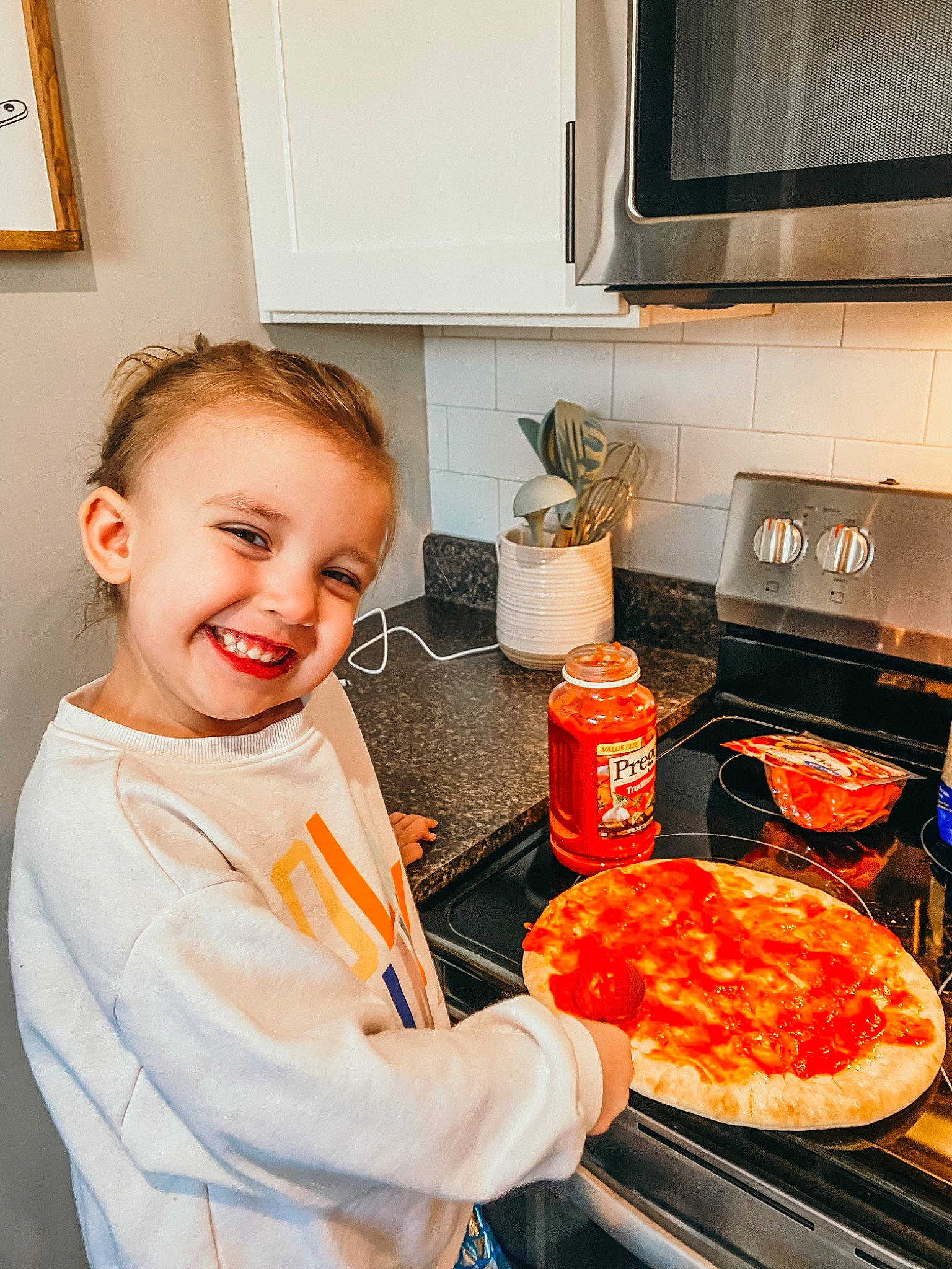 Winsley Kate joined the competition — help win amazing prizes! cabinetry, cooking, cookware_and_bakeware, countertop, cuisine, dish, food, home_appliance, homemaker, ingredient, joy, kitchen, kitchen_appliance, major_appliance, microwave_oven, orange, person, picture_frame, recipe, smile