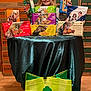 Brenley is registered to the contest to win money with this photo: background, child, cookie_boxes, display, fabric, food, girl, girl_scouts, happy, indoors, packaging, person, portrait, retail, selling, smiling, stacked_boxes, table, tote_bag, wood_floor