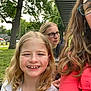 Brenley joined the competition — help win amazing prizes! adult, blonde_hair, casual_clothing, child, curly_hair, daylight, face, glasses, grass, greenery, group, happy, nature, outdoor, park, person, portrait, smiling, sunlight, tree