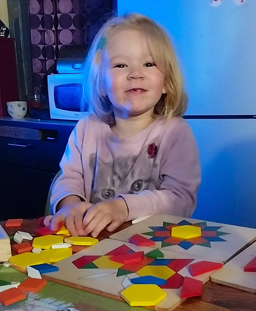 Athéna participe au concours pour gagner de l'argent avec cette photo : art, blue, cabinetry, chair, child, flooring, fun, happy, indoor_games_and_sports, joy, leisure, person, plastic, play, recreation, room, smile, t_shirt, table, toddler