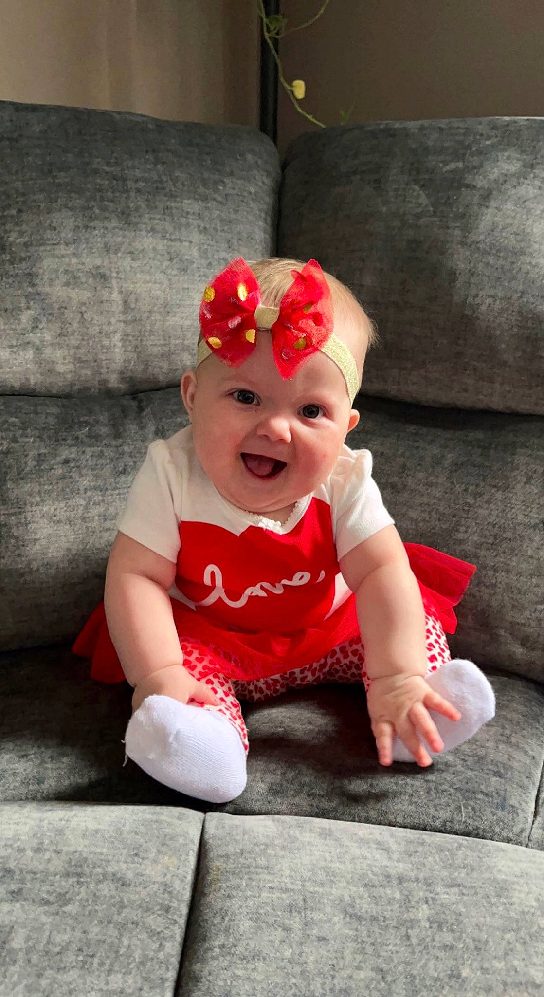 Harper joined the competition — help win amazing prizes! baby, baby_toddler_clothing, cap, carmine, child, costume, costume_accessory, costume_hat, fashion_accessory, flower, fun, happy, hat, head, headgear, headwear, person, sitting, sleeve, smile
