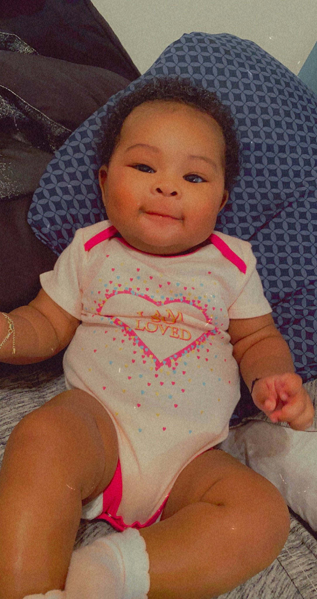 Dalani joined the competition — help win amazing prizes! abdomen, baby, baby_toddler_clothing, cheek, child, hand, head, human_body, lip, mouth, pattern, person, pink, sitting, skin, stomach, tan, thigh, thumb, toddler