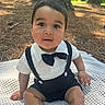 Bryson is registered to the contest to win money with this photo: baby, child, outdoor, nature, trees, blanket, bow_tie, suspenders, cute, infant, grass, sunlight, portrait, sitting, forest, young, person, happy, casual, daylight