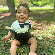 Bryson joined the competition — help win amazing prizes! toddler, child, baby, grass, outdoor, park, sunlight, greenery, tree, nature, cute, smiling, sitting, clothing, bow_tie, happy, portrait, daytime, barefoot, young