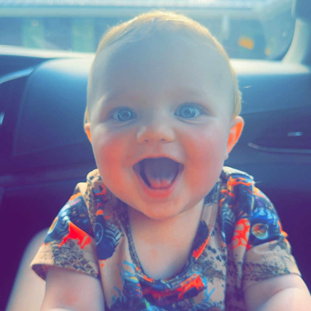 Easton joined the competition — help win amazing prizes! baby, blue_eyes, bright, car_interior, child, colorful_clothing, cute, daylight, expression, fun, happy, holding_hand, human, infant, joyful, portrait, short_hair, sitting, smiling, sunlight