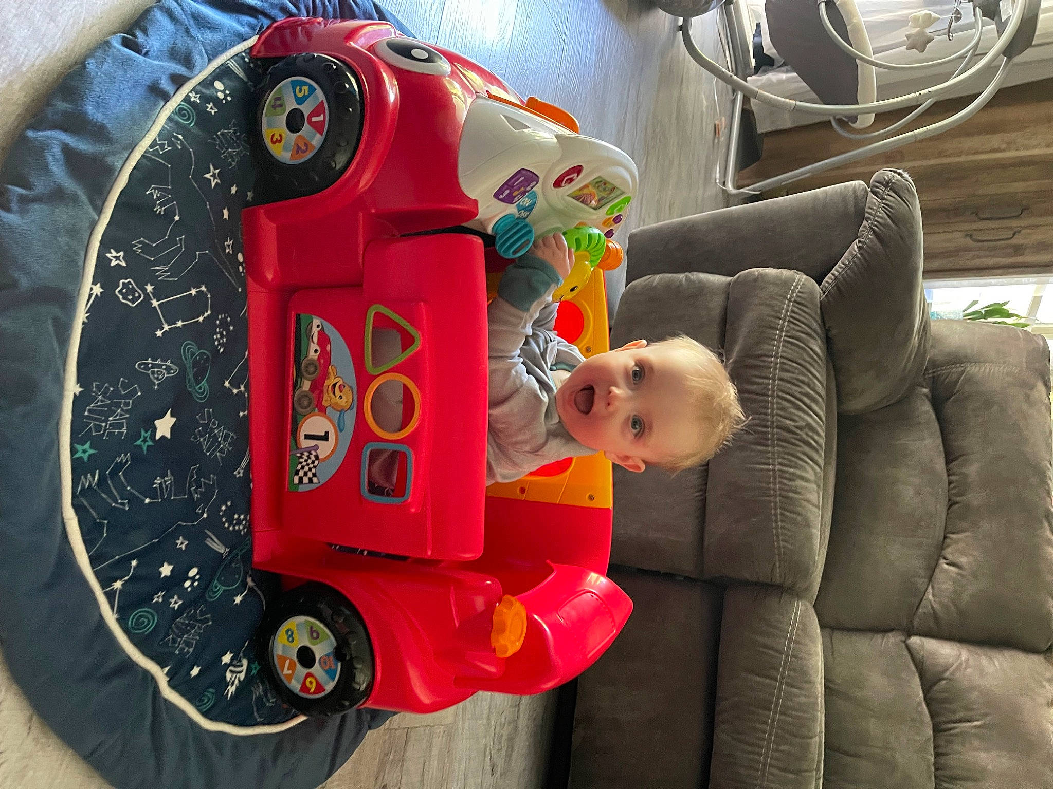 Bodhi is registered to the contest to win money with this photo: art, auto_part, automotive_design, automotive_exterior, automotive_lighting, automotive_tire, automotive_wheel_system, baby_products, child, comfort, fun, machine, mechanical_fan, mode_of_transport, motor_vehicle, person, surprise, tire, toddler, toy