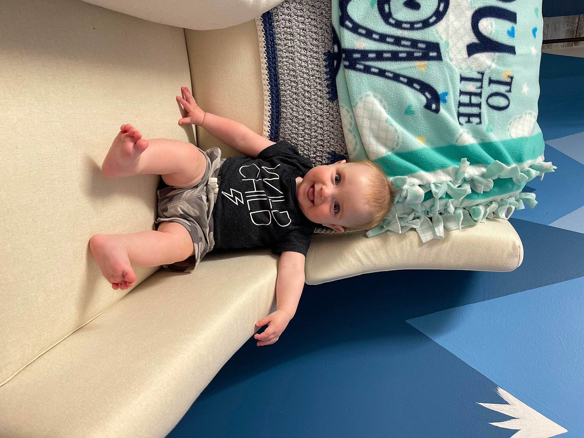 Bodhi is registered to the contest to win money with this photo: baby, baby_toddler_clothing, child, comfort, couch, flash_photography, font, foot, happy, hat, human_leg, joy, knee, leg, leisure, person, sitting, sleeve, sock, t_shirt