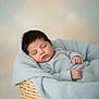 baby, sleeping, blanket, basket, cozy, infant, peaceful, soft, pastel, portrait, newborn, cute, child, hands, face, knitted_blanket, resting, indoors, closeup, calm