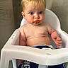 George is registered to the contest to win money with this photo: baby, high_chair, messy_face, blond_hair, blue_shorts, indoor, child, serious_expression, food_stain, toddler, skin, bare_chest, plastic_chair, sitting, person, young_child, cute, messy, mouth, expression