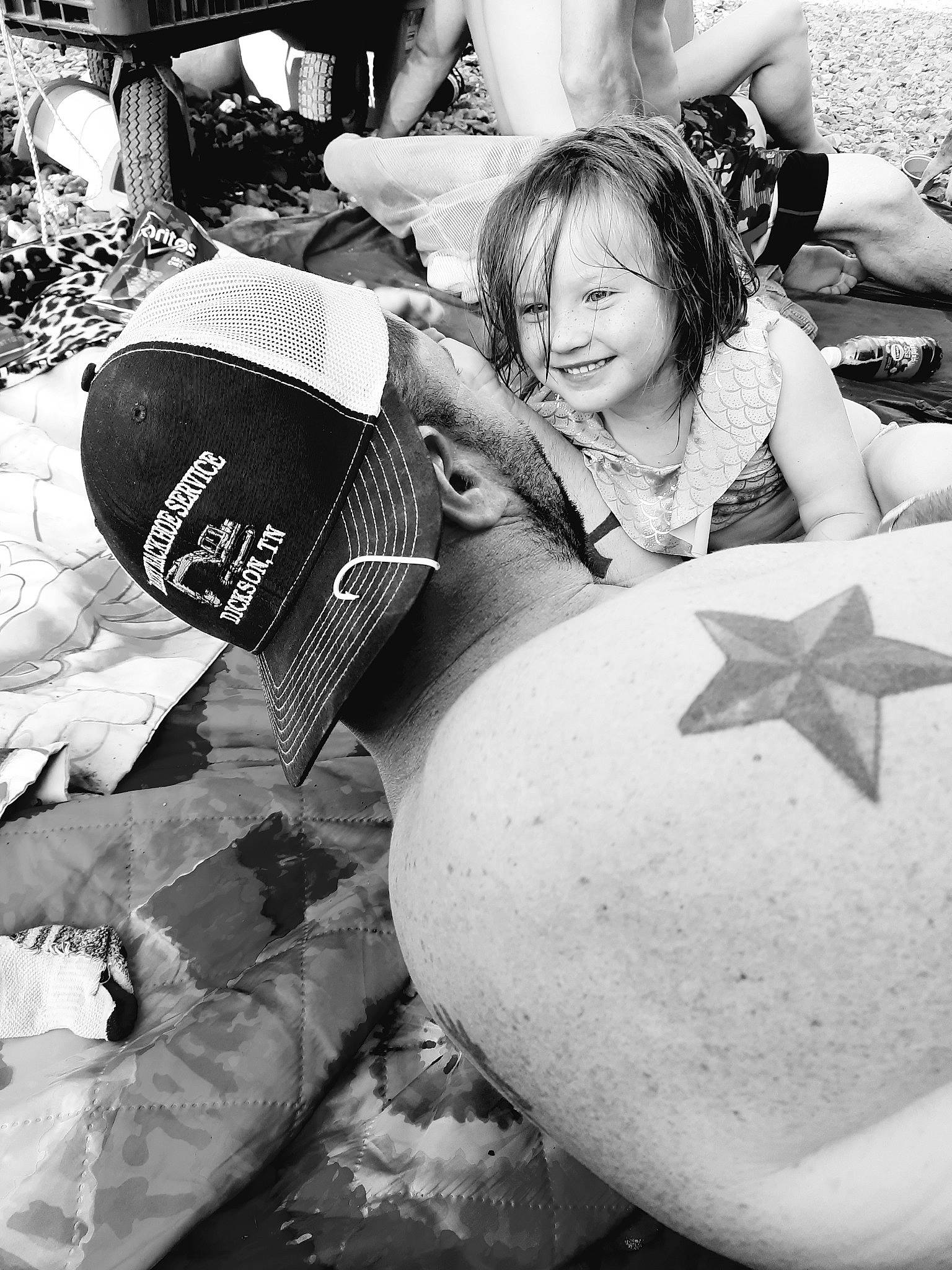 Bentley is registered to the contest to win money with this photo: ball, black, black_and_white, eyewear, football, grass, guitar_accessory, happy, joy, monochrome, monochrome_photography, musical_instrument, people, person, photograph, recreation, sitting, smile, snapshot, street
