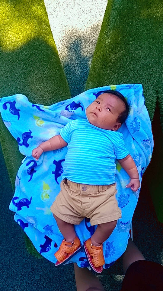 Abel joined the competition — help win amazing prizes! aqua, azure, baby, baby_products, baby_toddler_clothing, child, comfort, electric_blue, fun, grass, happy, leisure, linens, pattern, people_in_nature, person, product, purple, sitting, sleeve