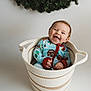 Waylon joined the competition — help win amazing prizes! baby, smiling, basket, pajamas, indoor, happy, child, cute, face, portrait, holiday, wreath, greenery, cozy, infant, sitting, clothing, expression, studio, cute_face