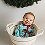 Waylon is registered to the contest to win money with this photo: baby, child, basket, pajamas, smile, face, indoor, holiday, wreath, greenery, cute, infant, striped, soft, cozy, seated, happy, portrait, colorful, festive