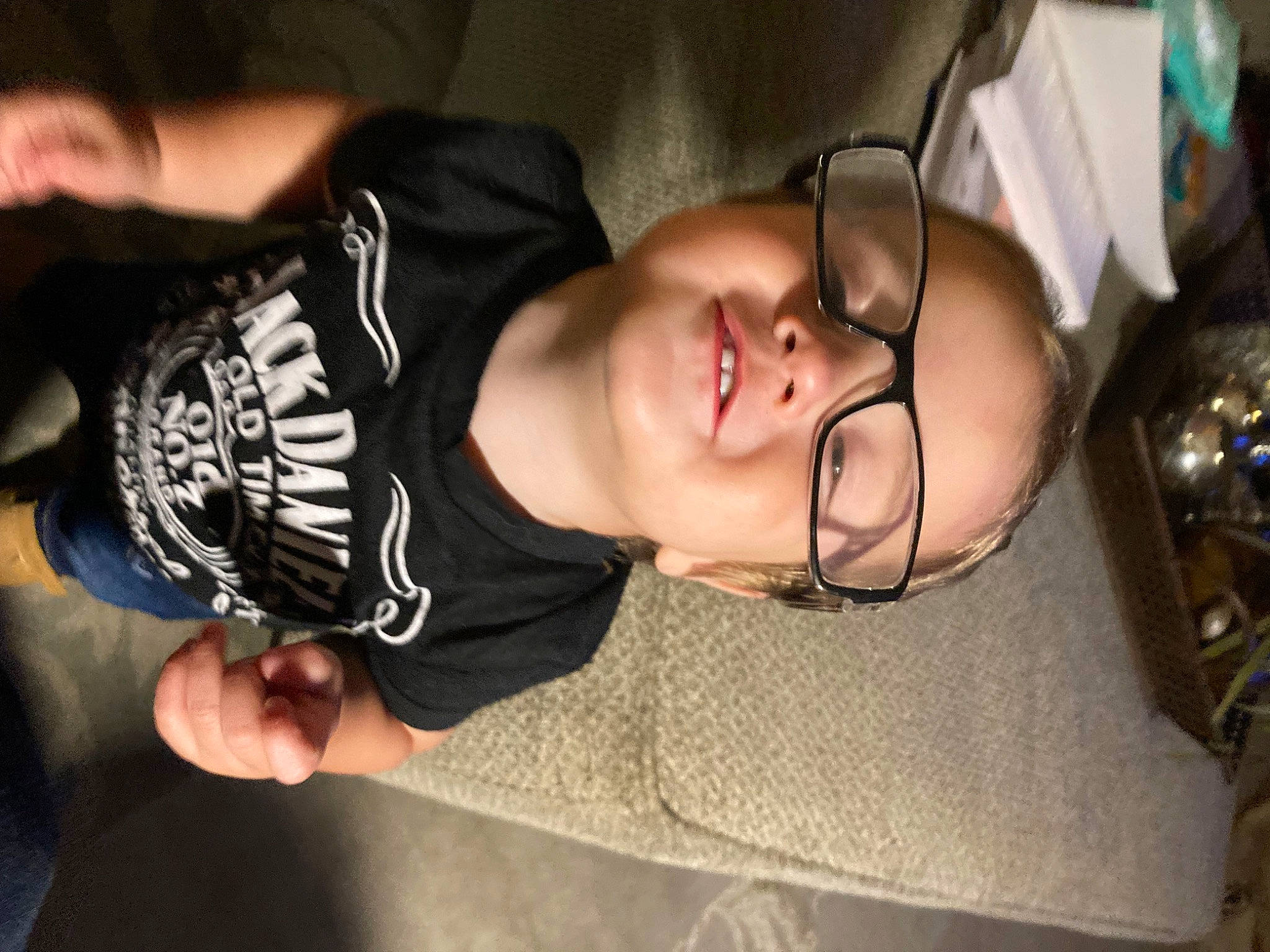 Colton is registered to the contest to win money with this photo: black_hair, cheek, comfort, ear, elbow, eyebrow, eyewear, finger, flash_photography, glasses, happy, jaw, joy, mouth, neck, nose, person, sleeve, smile, t_shirt