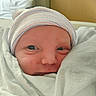 Lincoln is registered to the contest to win money with this photo: newborn, baby, infant, face, wrapped, blanket, hospital, hat, portrait, closeup, cute, child, sleepwear, soft, newborn_baby, person, skin, eyes, headwear, indoors